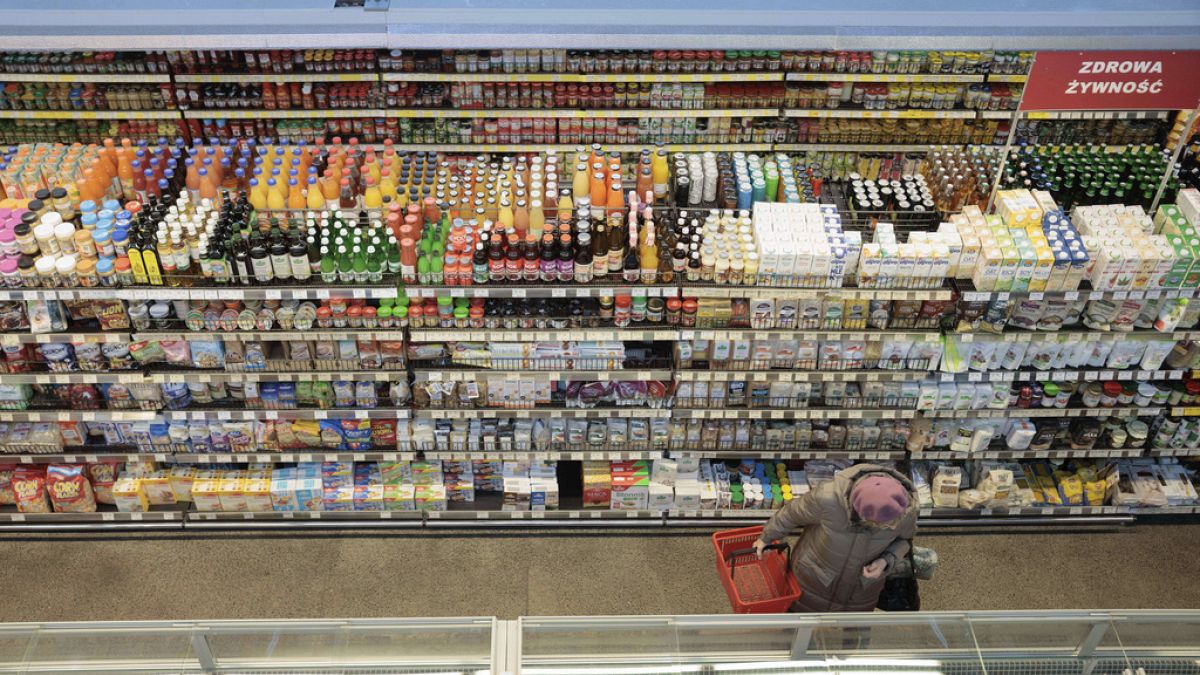 FILE - A woman shops at a supermarket in Warsaw, Poland, on Dec. 9, 2022. Poland's central bank lowered its interest rates by 75 basis points on Wednesday Sept. 6, 2023 despit