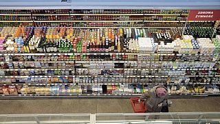 FILE - A woman shops at a supermarket in Warsaw, Poland, on Dec. 9, 2022. Poland's central bank lowered its interest rates by 75 basis points on Wednesday Sept. 6, 2023 despit
