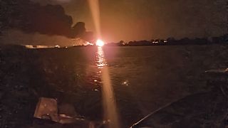 A fireball lights the horizon on the Ukrainian shore of the Danube, seen from Chilia Veche in eastern Romania on the night of Tuesday, Sept. 5, 2023