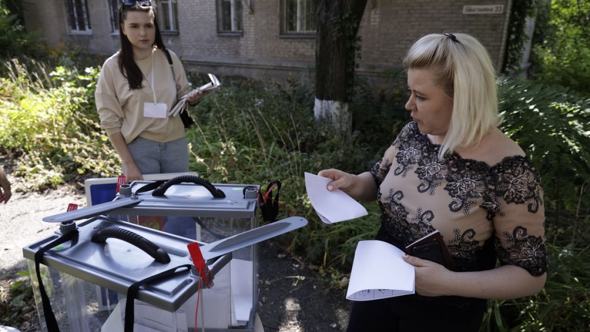 A woman prepares to cast her ballot during early voting in local elections in Donetsk, the capital of Russian-controlled Donetsk region, eastern Ukraine, on , Sept. 6th , 2023