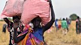 Locals in South Sudan collect the food drop of grain, delivered by the World Food Programme.