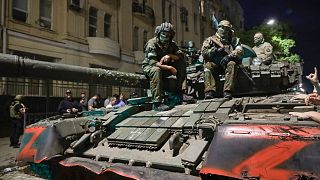 Members of the Wagner Group military company sit atop of a tank on a street in Rostov-on-Don, Russia, Saturday, June 24, 2023.