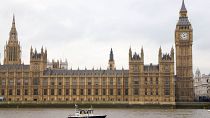 A police launch boat passes The Houses of Parliament in London