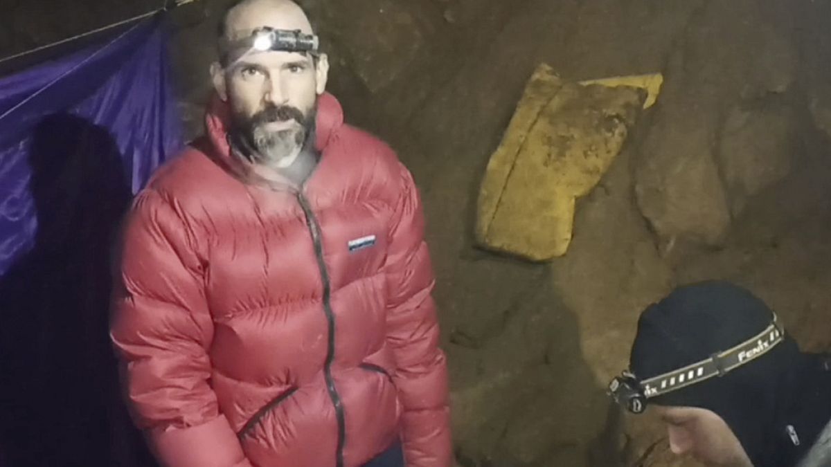 In this screen grab from video, American caver Mark Dickey, 40, talks to camera next to a colleague inside the Morca cave near Anamur, southern Turkey, Thursday, Sept. 7, 2023