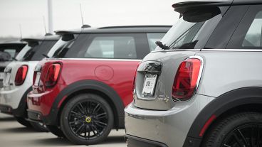 Unsold 2024 Cooper SE electric hardtops sit Friday, April 14, 2023, at a Mini dealership in Highlands Ranch, Colo.