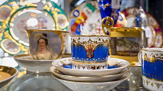 A cup adorned with the royal family of Savoy's coat of arms is displayed in a showcase ahead of sales at Geneve Encheres auction house