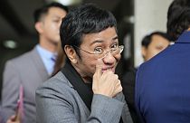 Filipino journalist Maria Ressa, 2021 Nobel Peace Prize winner and Rappler CEO, gestures as she talks to reporters after being acquitted