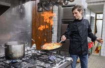 Vitaly from Kyiv helps in the kitchen with the Glas family in Dippertz, Germany, Tuesday, April 5, 2022.