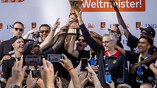 The German basketball team celebrates with fans after their arrival in Frankfurt, Germany, Tuesday, Sept. 12, 2023. 