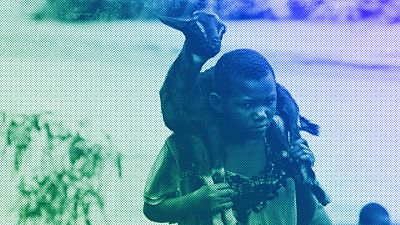 A child carries a goat on her shoulders through a flooded river caused by last week's heavy rains caused by Tropical Cyclone Freddy in Phalombe, southern Malawi, March 2023