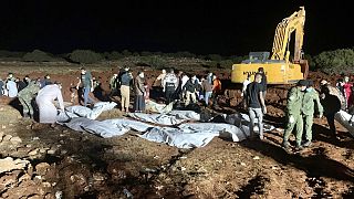 Workers bury the bodies of victims of recent flooding caused by Mediterranean storm Daniel near the city of Derna, Libya, Wednesday, Sept. 13, 2023.