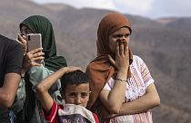 Smell of death overwhelms people as a body of a woman who was killed by the earthquake is recovered, in the town of Imi N'tala, outside Marrakech, Morocco, Tuesday, Sept. 12,