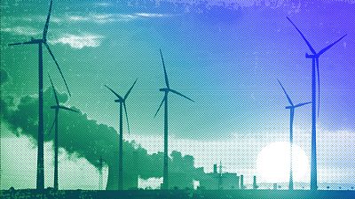 Steam rises from the coal-fired power plant near wind turbines in Niederaussem, November 2022