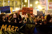 Women march behind a banner during a rally to mark the International Women's Day in Zagreb on March 8, 2023.