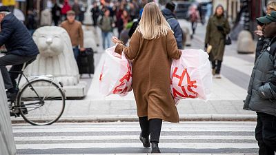 A woman carries plastic bags at the Drottninggatan shopping street in central Stockholm
