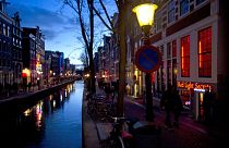 The entrance of the 'Red Light Secrets' prostitution museum is seen, right, in Amsterdam.