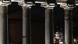 Motorists are framed by the columns of the Temple of Saturn of the Roman Forum, in Rome, Tuesday, 13 December 2022.