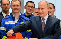Russian President Vladimir Putin, foreground right, attends the launch ceremony for the first technological line for liquefying natural gas on gravity bases, July 20, 2023