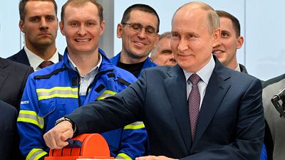 Russian President Vladimir Putin, foreground right, attends the launch ceremony for the first technological line for liquefying natural gas on gravity bases, July 20, 2023