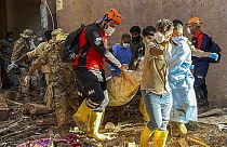 In this photo provided by Turkey's IHH humanitarian aid group, rescuers retrieve the body of a flooding victim in Derna, Libya, Wednesday, Sept.13, 2023. 