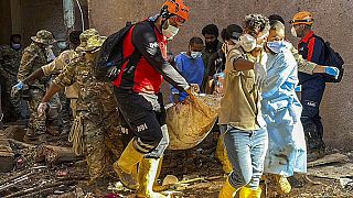 In this photo provided by Turkey's IHH humanitarian aid group, rescuers retrieve the body of a flooding victim in Derna, Libya, Wednesday, Sept.13, 2023.
