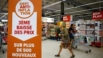 A sign reading "Anti-inflation challenge, third price cut on more than 500 new products" at a Carrefour supermarket near Paris, 13 September 2023