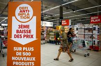 A sign reading "Anti-inflation challenge, third price cut on more than 500 new products" at a Carrefour supermarket near Paris, 13 September 2023