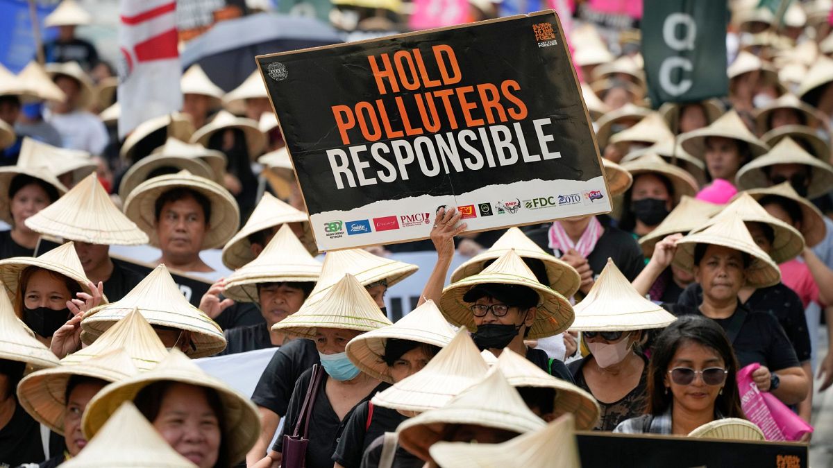 Protesters hold slogans as they join the global march to end fossil fuel on 15 September 2023, in Quezon city, Philippines. 