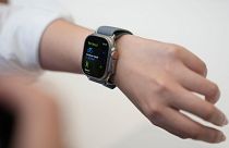 A person tries on an Apple Watch during an announcement of new products on the Apple campus, 12 September 2023, in Cupertino, California.