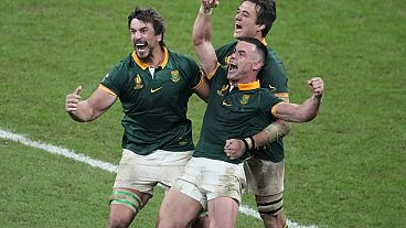 South Africa players celebrate at the end of the Rugby World Cup final match between New Zealand and South Africa at the Stade de France in Saint-Denis, near Paris Saturday, O