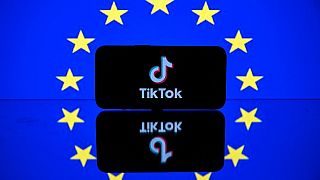 Экран с логотипом социальной сети Tiktok и европейским флагом