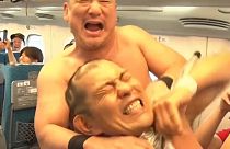 Japanese professional fighters wrestle in the Shinkansen