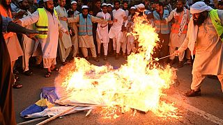 FILE - People burn Sweden's flag during a demonstration in Lahore over Quran burnings in Stockholm on July 9, 2023