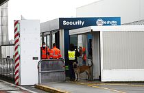 FILE - Custom officers stand at the check point on the Eurotunnel site, meters before the tunnel linking France to Britain, in Coquelles, northern France
