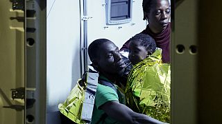 Rescued migrants disembark from a boat on the Italian island of Lampedusa during the evening of Saturday, Sept. 16, 2023. 