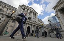 A man walks past the Bank of England, at the financial district in London, on May 11, 2023.
