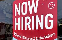 Un cartello con un'offerta di posti di lavoro in un fast food