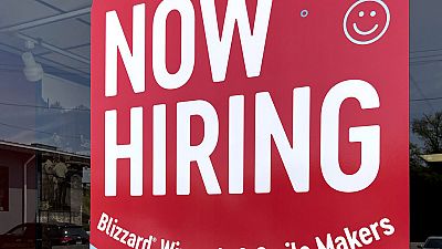 File - A hiring sign is displayed at a fast food restaurant. 