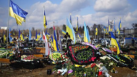 FILE - The grave of Yana Rikhlitska, 29, a Ukrainian army as a medic killed in the Bakhmut area, during the funeral in Vinnytsia, Ukraine, Tuesday, March 7, 2023.