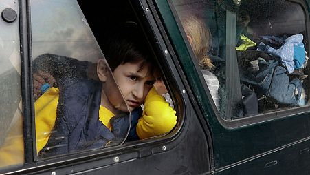 An ethnic Armenian boy from Nagorno-Karabakh, looks on from a car upon arrival in Armenia's Goris, the town in Syunik region, Armenia