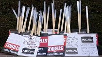 Placards are gathered together at the close of a picket by members of The Writers Guild of America outside Walt Disney Studios