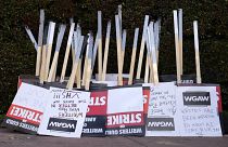 Placards are gathered together at the close of a picket by members of The Writers Guild of America outside Walt Disney Studios