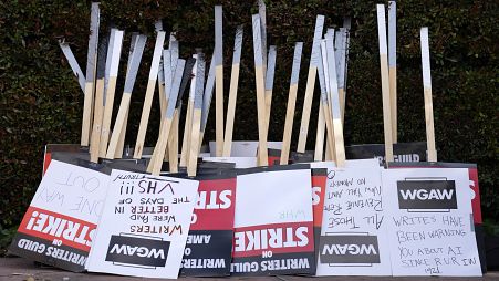 Placards are gathered together at the close of a picket by members of The Writers Guild of America outside Walt Disney Studios