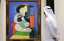 A visitor looks at Pablo Picasso’s painting 'Femme à la montre' displayed for viewing at Sotheby’s Dubai on September 25, 2023.
