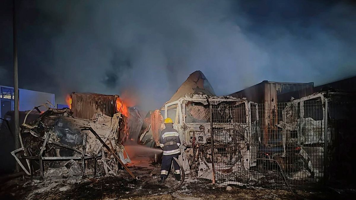 In this photo provided by regional authorities, firefighters work to extinguish a fire at a site of a Russian attack near the seaport in Odesa, Ukraine.