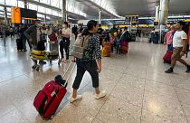 FILE - Travelers at Heathrow Airport in London, 13 July 2022. 