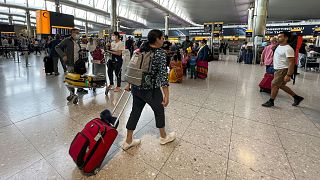 FILE - Travelers at Heathrow Airport in London, 13 July 2022. 