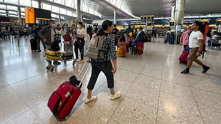 FILE - Travelers at Heathrow Airport in London, 13 July 2022. 