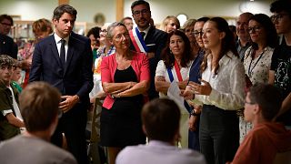 French Education Minister Gabriel Attal stands with French Prime Minister Elisabeth Borne as they visit the Simone-Veil secondary school, on the first day of the academic year