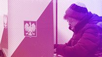 A woman reads her ballot before casting during general elections in Warsaw, October 2015